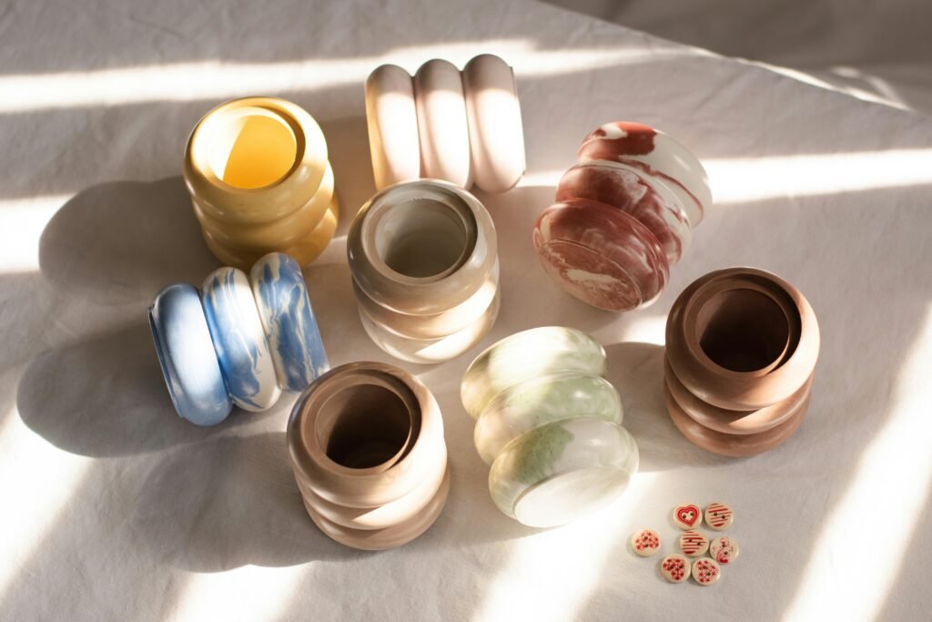 An arrangement of various handcrafted ceramic vases in natural light, showcasing colors and textures.